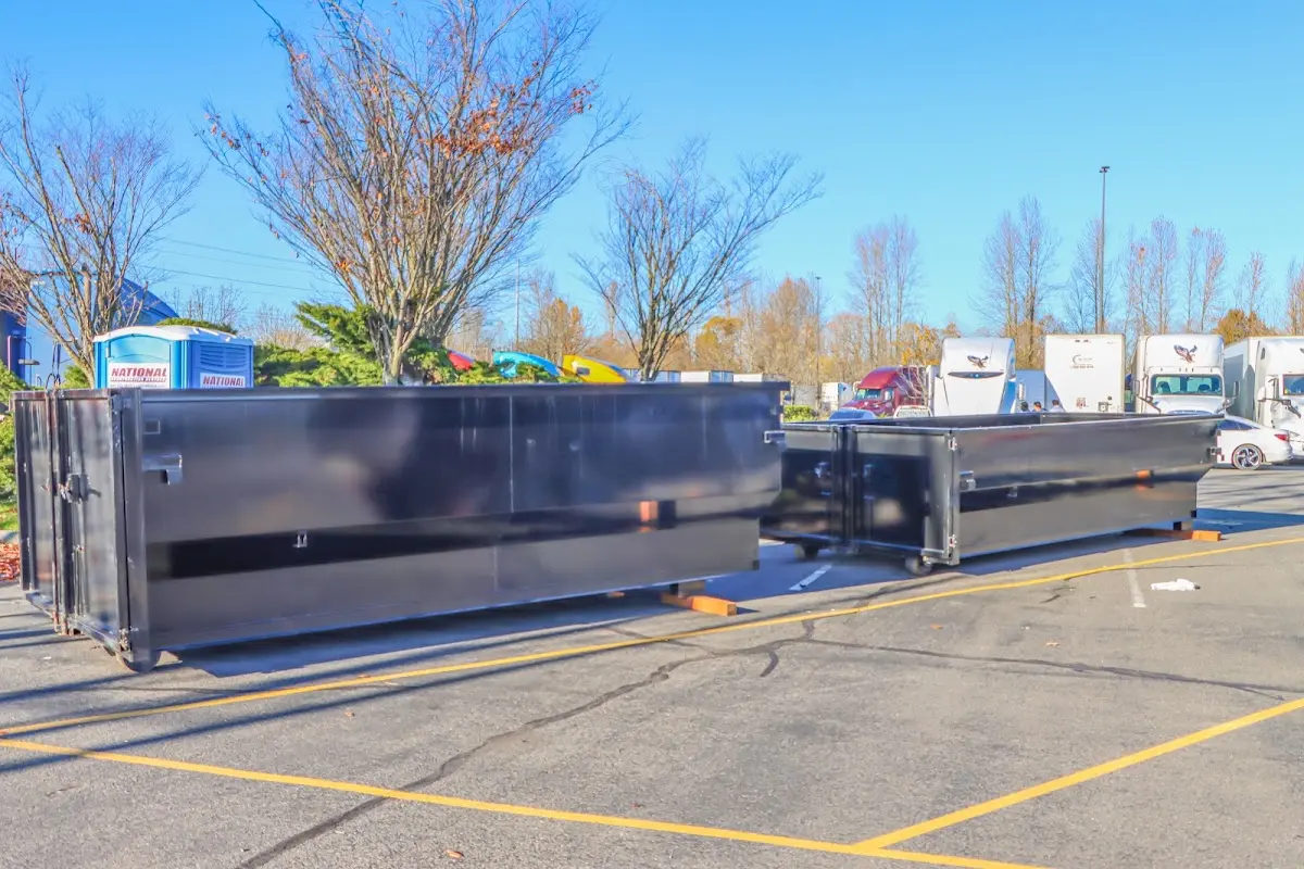 Professional dumpster rental service with roll-off container on residential driveway in Elyria